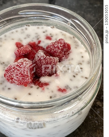 Frozen raspberries and chia seeds in yogurt overhead shot, ideal for food background use 130053055