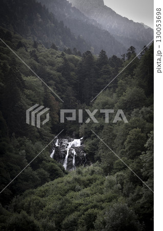 Discovering the serene beauty of Cauteret cascade in the Pyrenees amid lush green forests and 130053698