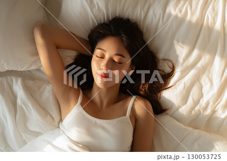 布団/ベッドで安らかに眠る女性/睡眠/安眠 130053725