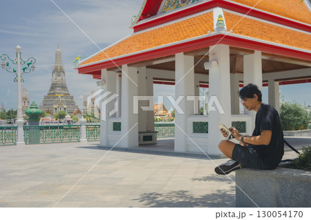 solo travel with asian man chilling and use tablet work in city life at bangkok thailand in summer season solo travel with asian man chilling and use tablet work in city life at bangkok thailand in summer season 130054170