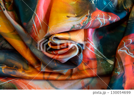 Beautiful textile silk scarf. Yellow, orange, brown handmade texture fabric. Fashion background. 130054699