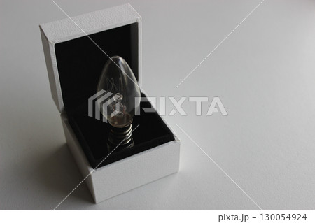 Candle Bulb In A Jewelry Box Isolated On White Surface Copy Space Image 130054924