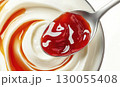 Yogurt with berry jam on spoon, isolated on white background, package design element 130055408