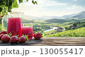 Strawberry juice in glass jug with fresh raspberries on rustic wooden table, countryside background, copy space 130055417