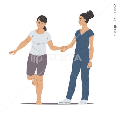 Physiotherapist helps woman balance exercise standing on one leg 130055992