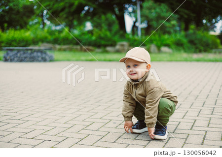 A Happy Toddler Playing Outdoors Joyfully in a Beautiful Park Setting A Truly Memorable and Joyful Moment Captured for Posterity, Showcasing the Wonders of Childhood and Exploration 130056042