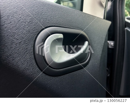 This closeup image highlights a sleek car door handle, showcasing modern functions, elegant design elements, and core automotive principles, enhancing user accessibility and comfort 130056227