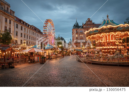 Oktoberfest sparkles at night with bright lights, rides and a festive atmosphere. Carousels and a fair on the square in Bavaria. 130056475