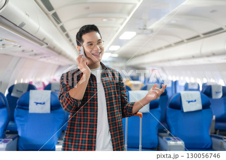 man, airplane, travel, enjoying comfortable flight while sitting in the airplane cabin. man, airplane, travel, enjoying comfortable flight while sitting in the airplane cabin. 130056746