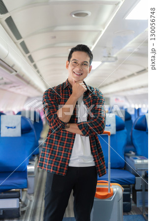 man, airplane, travel, enjoying comfortable flight while sitting in the airplane cabin. 130056748
