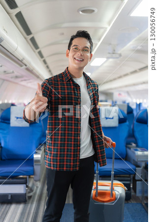 man, airplane, travel, enjoying comfortable flight while sitting in the airplane cabin. man, airplane, travel, enjoying comfortable flight while sitting in the airplane cabin. 130056749