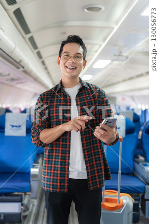 man, airplane, travel, enjoying comfortable flight while sitting in the airplane cabin. 130056773