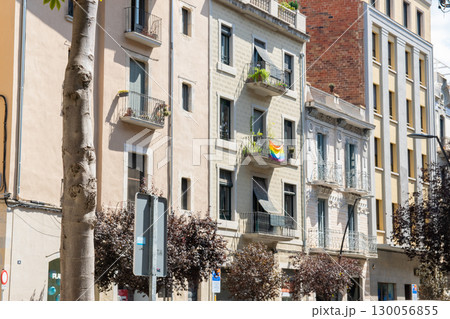 Flag with rainbow colors on a house with much beautiful balkone in Spain city.  130056855