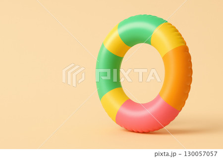 Inflatable pool float with tropical colors standing on minimal beige background, bright and playful summer accessory for water fun 130057057