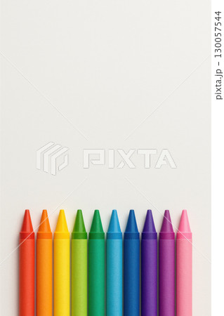 Crayon color set arranged in rainbow order on white background with wide empty space for text or design, bright and cheerful art supplies 130057544
