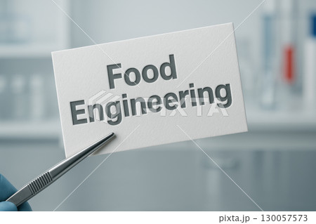 Food engineering text on textured paper held by laboratory tweezers in sterile research environment with soft focus background 130057573