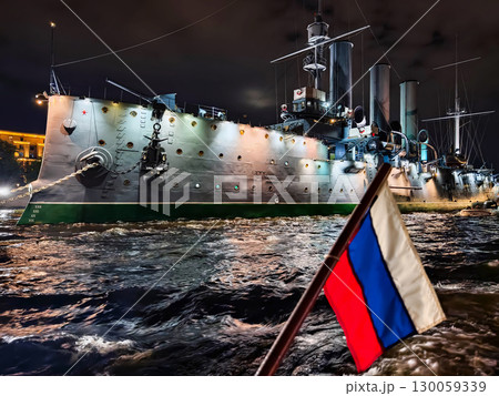 Historic warship illuminated at night near the riverbanks showcasing maritime heritage 130059339