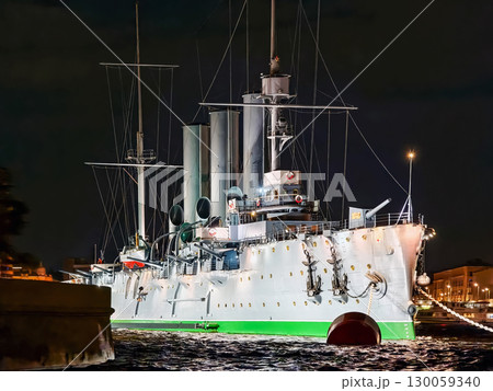 Historic warship illuminated at night near the waterfront showcasing naval architecture Historic warship illuminated at night near the waterfront showcasing naval architecture 130059340