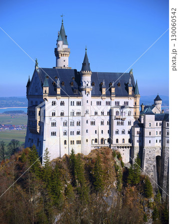 Majestic Neuschwanstein Castle perched on a mountain against a clear blue sky in Bavaria, Germany 130060542