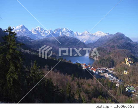 Stunning mountain landscape with lake, castle, and forests in Bavaria during clear day 130060555