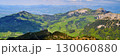 Majestic mountain landscape with rolling green hills under a bright sky in the Alps 130060880