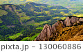 Scenic mountain view showcasing lush valleys and rocky outcrops during daytime in a rural landscape 130060886