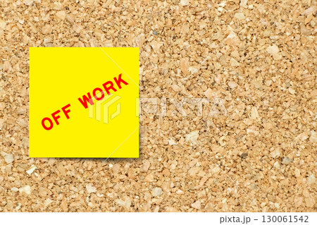 Yellow note paper with word off work on cork board background with copy space 130061542