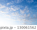 Clear blue sky with white cloud background 130061562