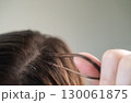 Woman with long hair extensions showing smooth strands and salon care after professional beauty treatment 130061875
