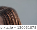 Young woman with hair extensions showing the result of a professional hairstylist work in a modern beauty salon 130061878