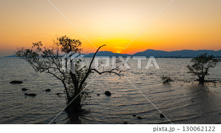 Aerial view of the golden sun slow down behind the mountain Aerial view of the golden sun slow down behind the mountain 130062122