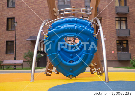 Children's playground in the courtyard of a residential building in the city 130062238