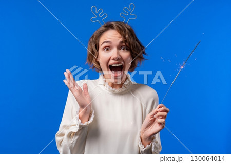 Pretty Woman With Sparkling Bengal Fire On Blue Background. Christmas Holidays 130064014