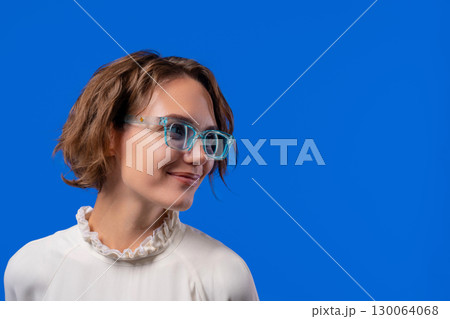 Smiling Woman In Transparent Blue Glasses. Positive Stylish Lady, copy space 130064068