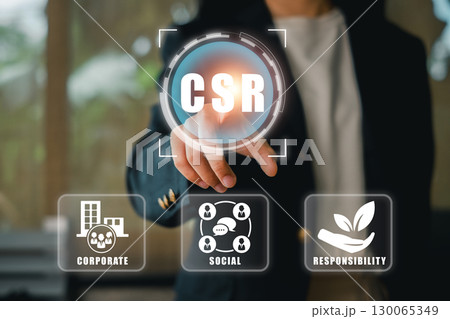 Business professional interacting with CSR digital interface, highlighting corporate responsibility and social impact. Business professional interacting with CSR digital interface, highlighting corporate responsibility and social impact. 130065349