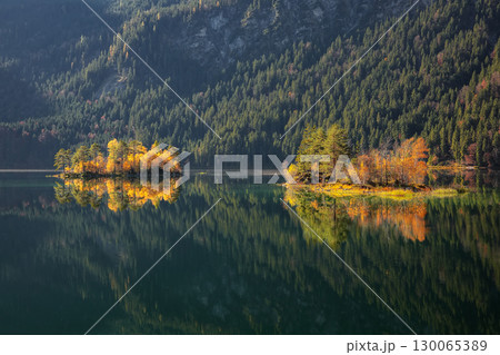 Fabulous autumn  landscape of islands with pine-trees in the middle of Eibsee lake. 130065389