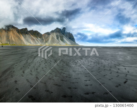 Amazing nasty day and dramatic black sand beach on Stokksnes cape in Iceland 130065400