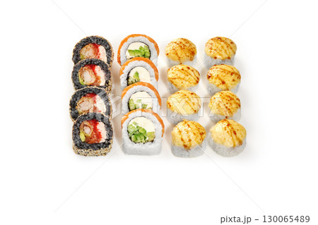 Sushi set displaying variety of rolls and nigiri on white background 130065489