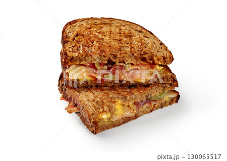 Toasted bacon, cheddar, and pickle sandwich on rye bread 130065517