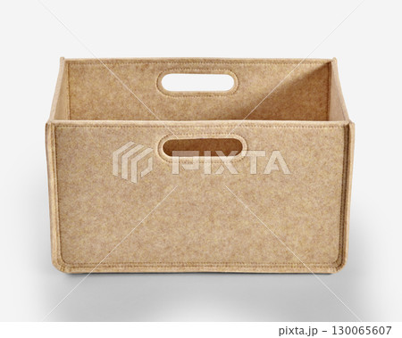 Empty beige felt storage box with handles on white background 130065607
