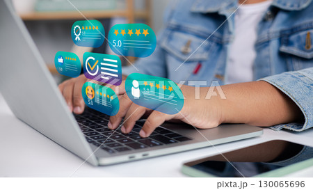 Customer review rating and feedback concept with five star icons on laptop screen Customer review rating and feedback concept with five star icons on laptop screen 130065696