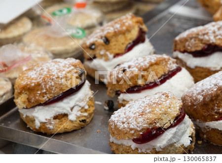 Delicious welsh cakes with jam and cream filling waiting in Cardiff market stall 130065837