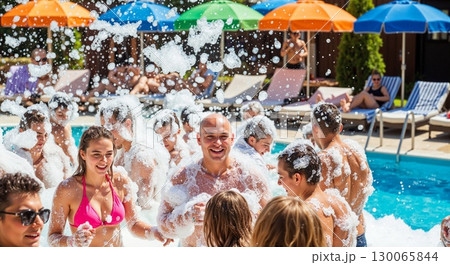 Joyful Pool Party Celebration With Friends Splashing Water Under Colorful Beach Umbrellas 130065844