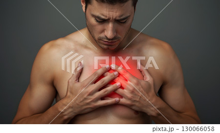 Intense Chest Pain Experience Shows Man Clutching Heart with Red Inflammation Highlight 130066058