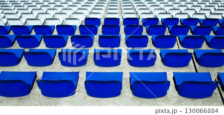 Empty Blue Stadium Seats Arranged in Perfect Geometric Rows at Sports Venue 130066884