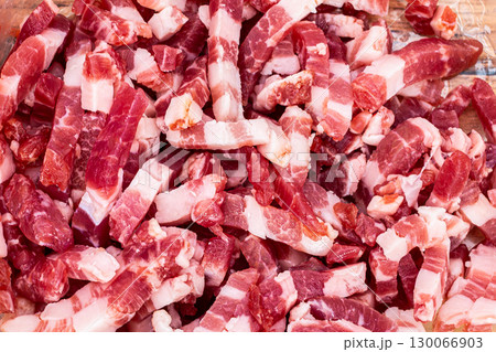 Diced bacon pieces showcasing marbled fat and lean meat texture for culinary preparation 130066903