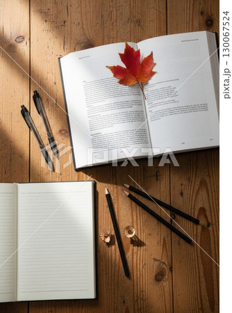 Back to School Still Life: Open Textbook and Stationery on Desk Back to School Still Life: Open Textbook and Stationery on Desk 130067524