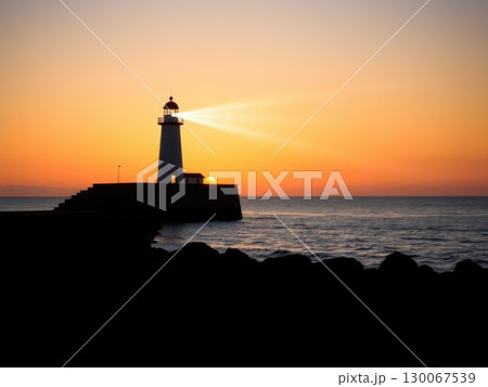 Powerful Lighthouse Beam at Golden Sunset or Sunrise 130067539