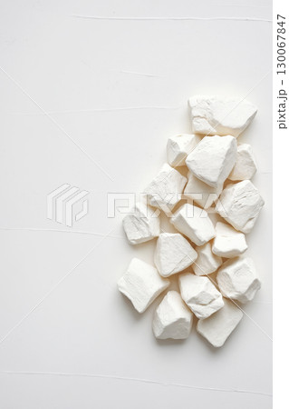 white chalk-like stones. Abstract minimalistic background white chalk-like stones. Abstract minimalistic background 130067847