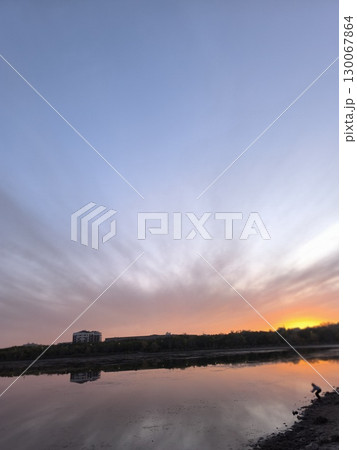 Serene Lake Sunset Landscape with Dramatic Clouds and Reflections for Peaceful Nature Scenery 130067864